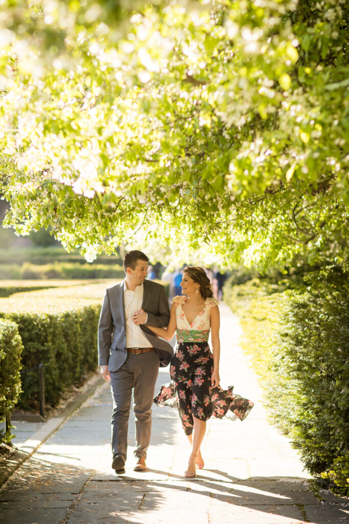 engaged couple walking in the conservatory gardens central park nyc