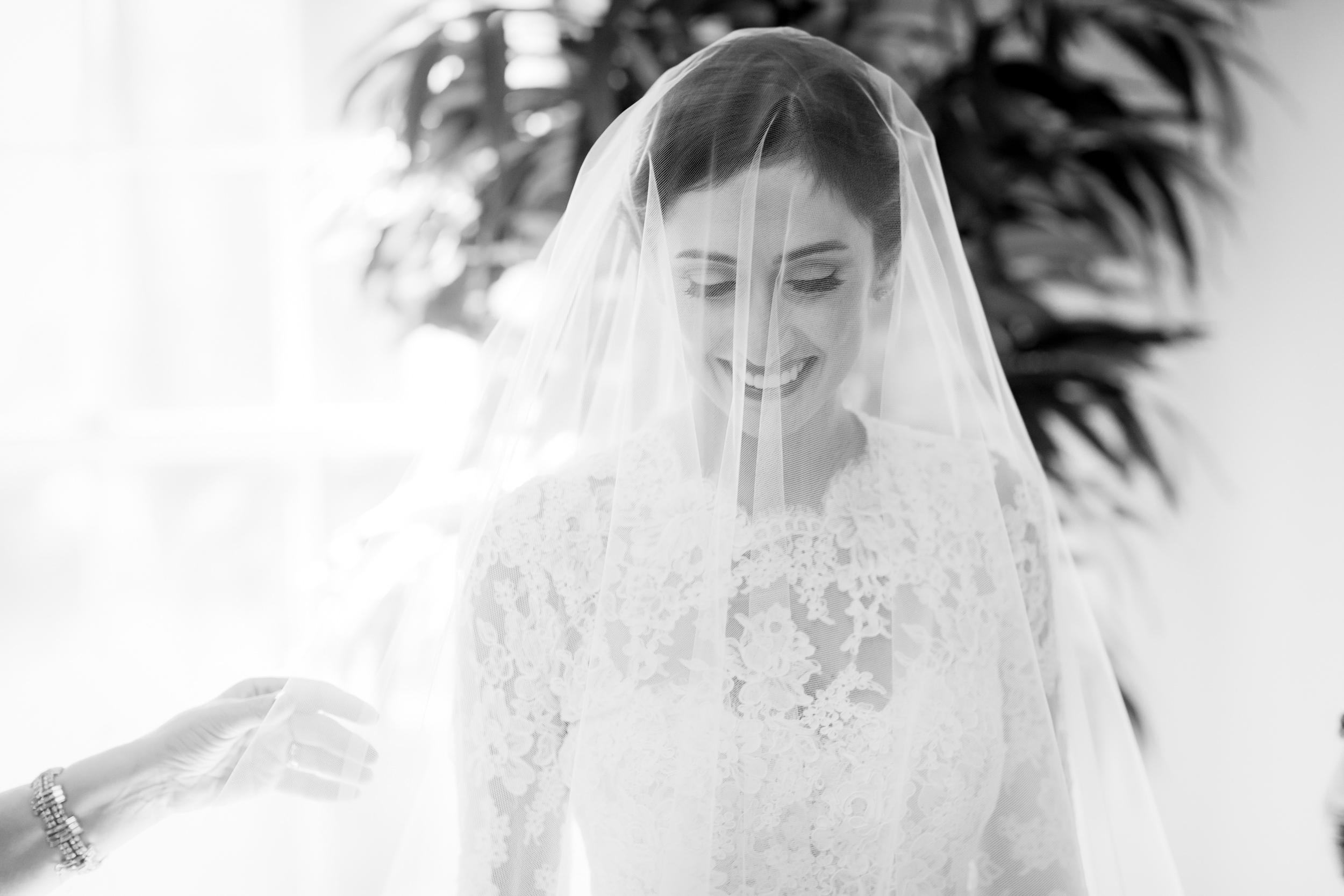 bride smiling with joy the firsts time she tries on her veil