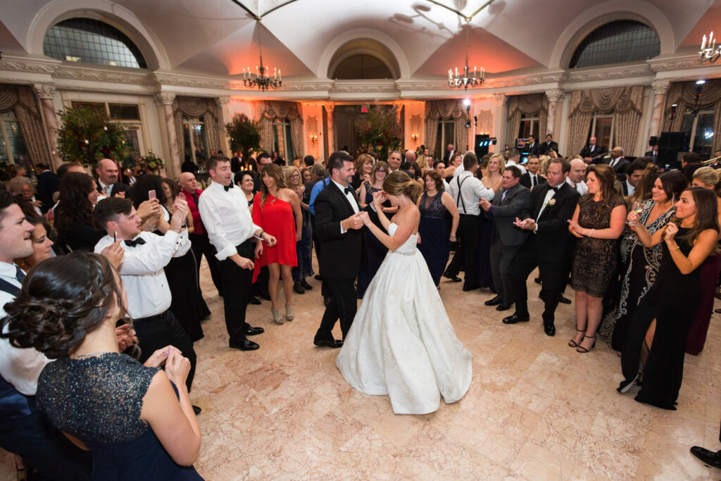 bride and groom dancing with guests