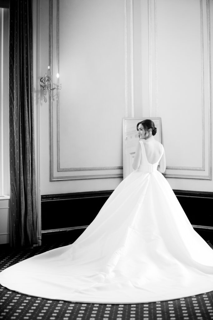 bride finished dressing in front of mirror