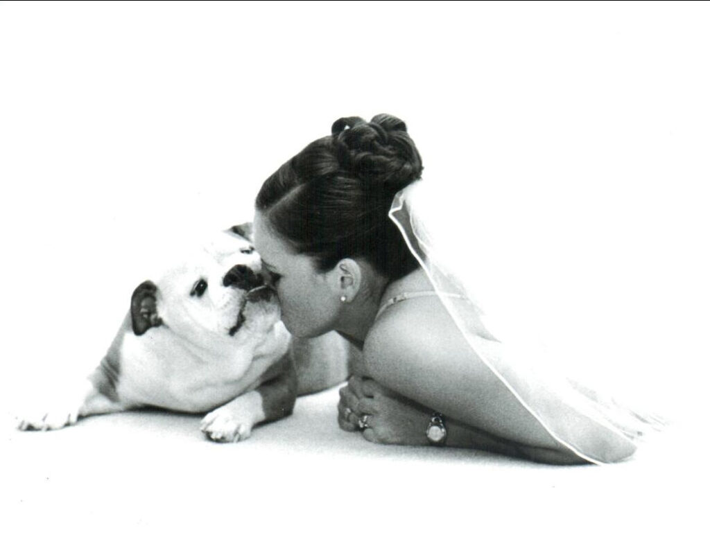 bride snuggling with her pug. black and white film